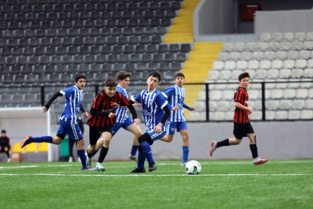 Young soccer players in action on a field. Ideal for sports and teamwork concepts.